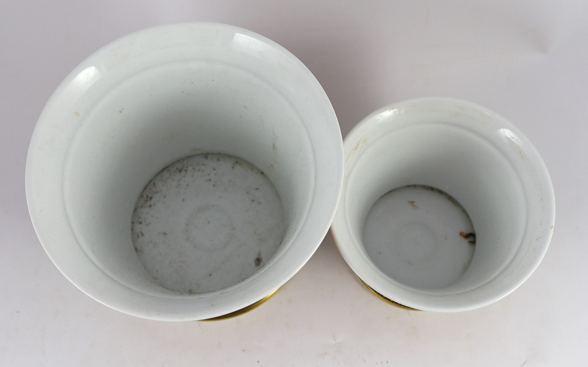 Rosenthal for Versace. A graduated pair of Medusa pattern jardinieres, 19.5cm and 14.5cm high